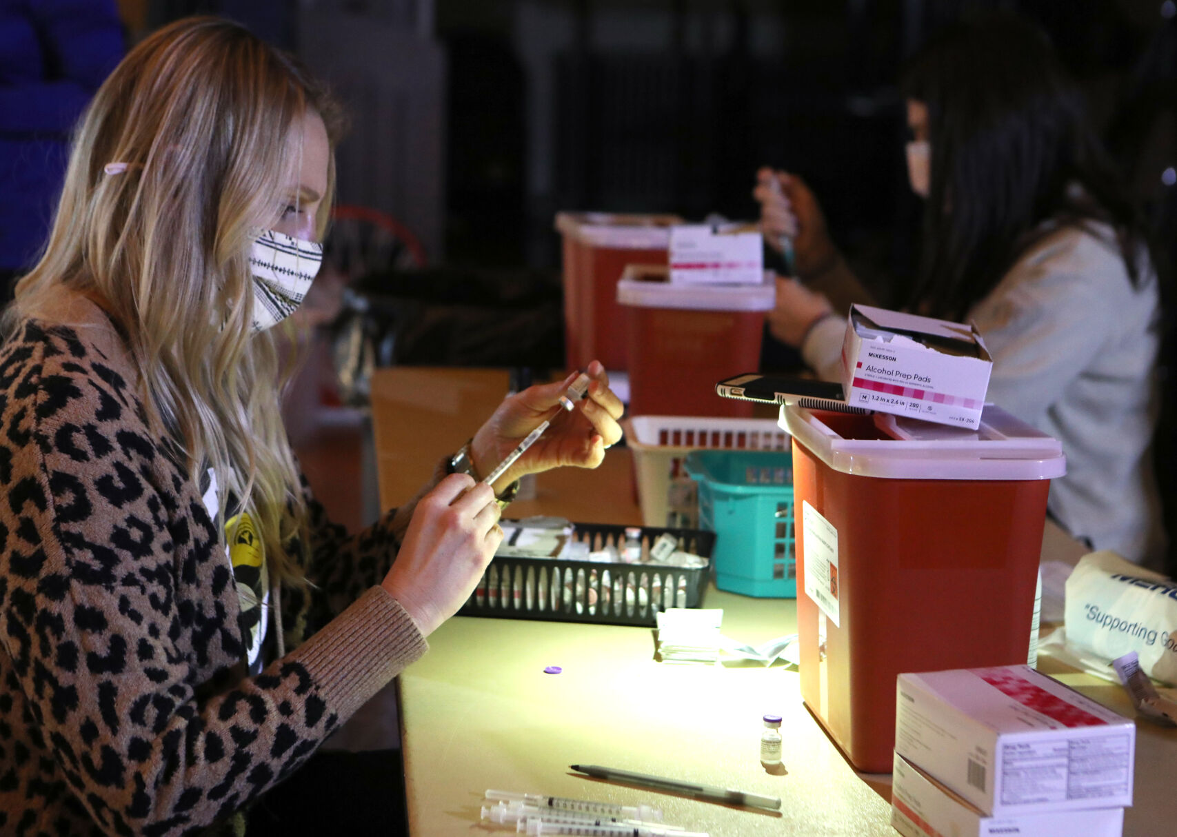 Lindsay Sorenson and Kayla Wallace prepare vaccines
